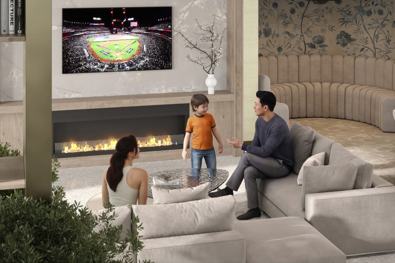 Residents lounge with deep seating, a linear gas fireplace, a large TV, and skyline artwork