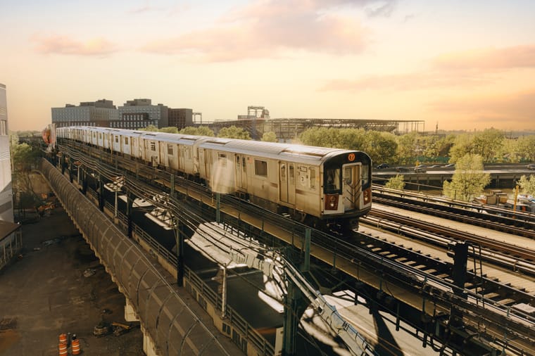 The elevated 7 train approaching a station at golden hour