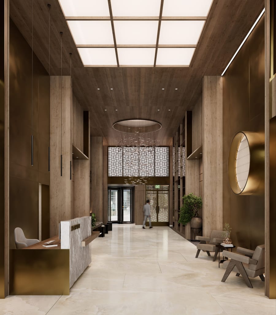 The double-height lobby with a bespoke chandelier and stone walls