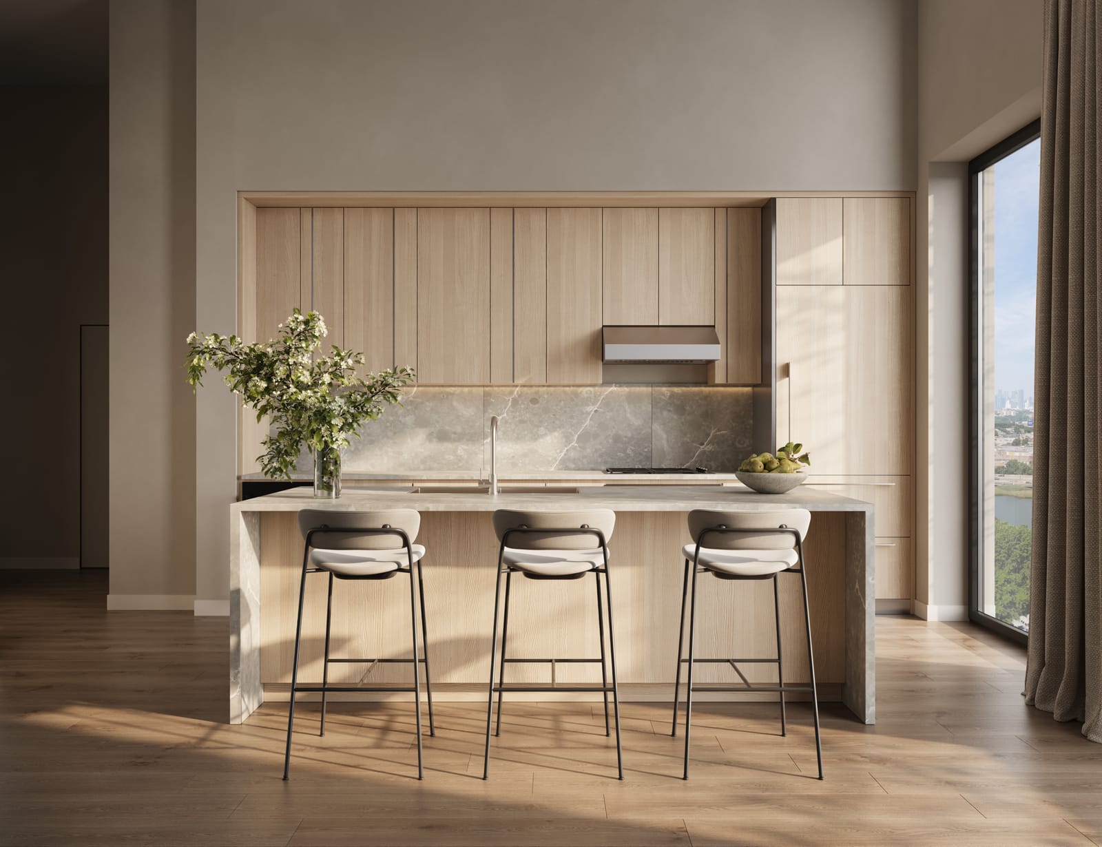 A Whitehall Interiors kitchen with pale oak cabinetry, a marble island, and sculptural bar stools