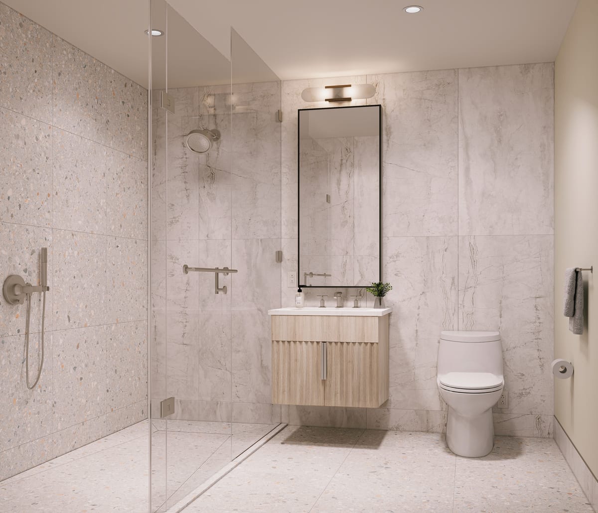 A residence bathroom with marble-veined walls, terrazzo floor, frameless glass shower, and a floating wood-grain vanity