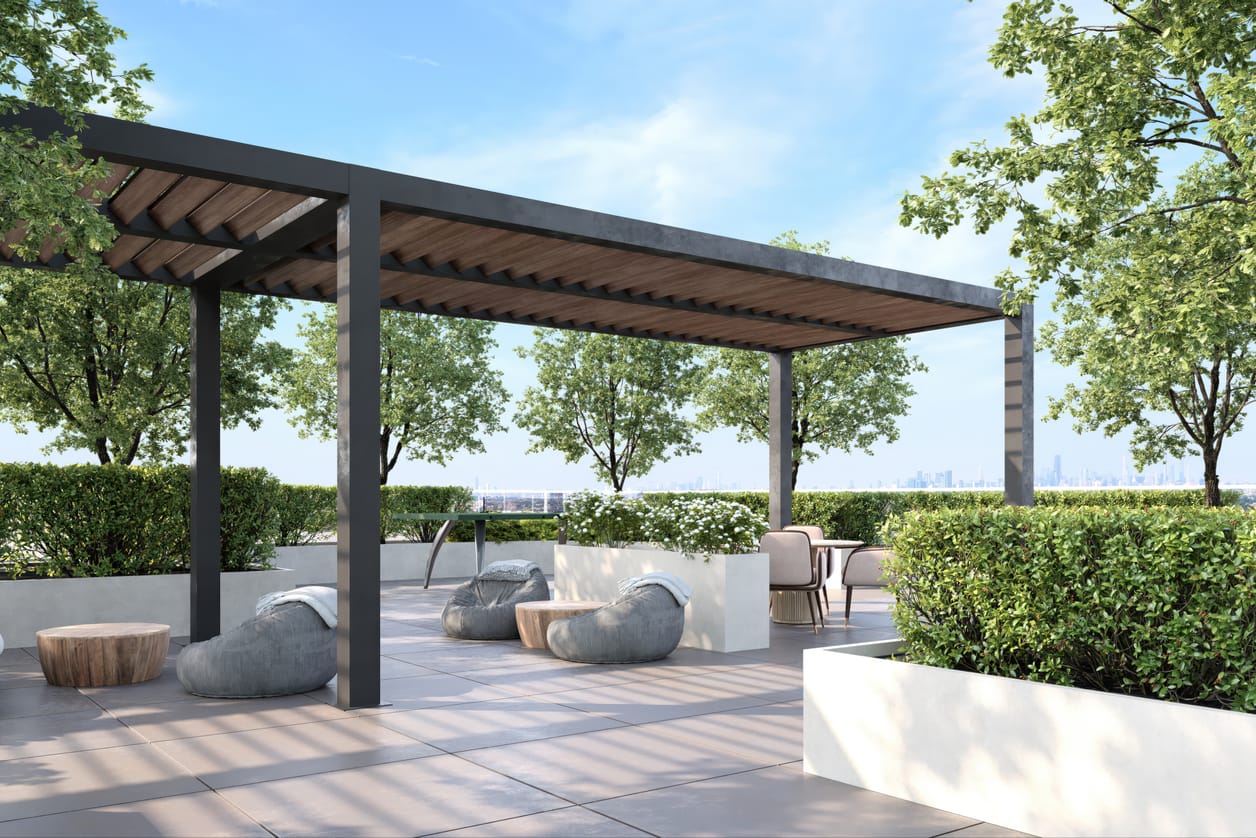 A pergola lounge with deep sectional seating surrounded by native planting