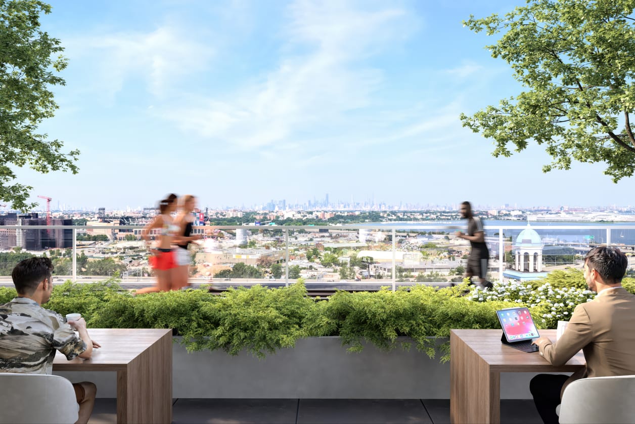 An outdoor workspace terrace with seating and skyline vistas